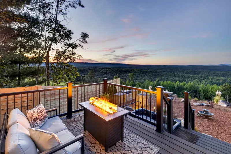 The deck fire table aglow as the sun sets over the valley