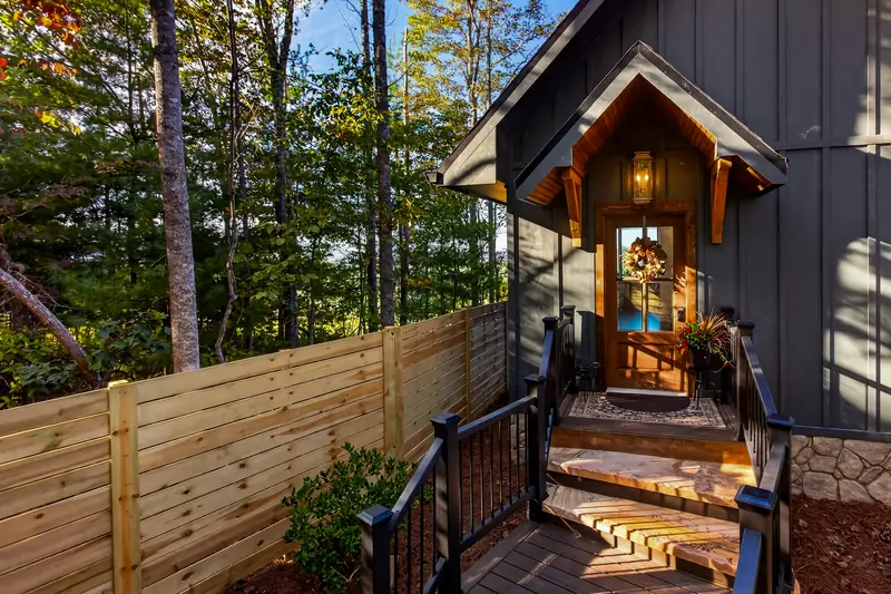 The lantern-lit private entrance beneath a timber gable