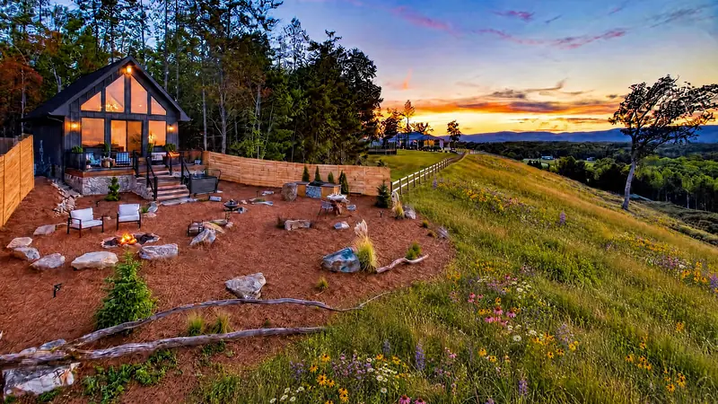 The grounds sloping toward the valley beneath an evening sky