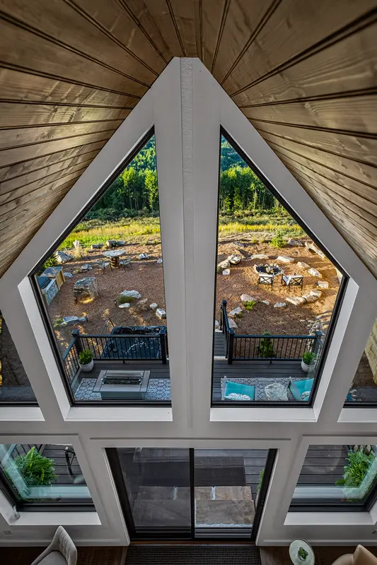 The A-frame windows rising to the peak of the ceiling